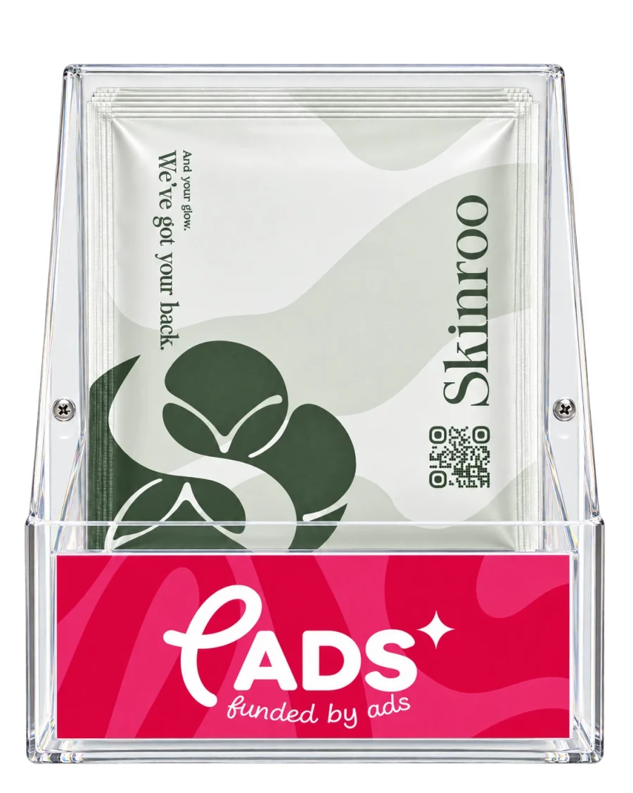 A P(ADS) stand stocked with Skinroo-branded envelopes that read: And your glow. We've got your back.